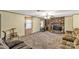 Inviting living room featuring a stone fireplace, plush carpeting, and a neutral color scheme with large windows for natural light at 4330 Rowell Rd, Lancaster, SC 29720