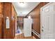 Walk-in pantry featuring wood paneling, storage shelves, and laminate flooring provides organization for kitchen essentials at 4330 Rowell Rd, Lancaster, SC 29720