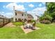 Lush backyard featuring a patio and fire pit, perfect for outdoor gatherings at 4469 Greystone Sw Dr, Concord, NC 28027