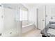 Bright bathroom featuring a shower, tub, neutral tile, and granite counters at 4469 Greystone Sw Dr, Concord, NC 28027