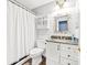 Bathroom with granite vanity, decorative mirror, and neutral color palette at 4469 Greystone Sw Dr, Concord, NC 28027