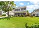 Charming two-story home with a spacious front yard, welcoming porch, and classic architectural details at 4469 Greystone Sw Dr, Concord, NC 28027