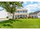 Charming two-story home with a spacious front yard, welcoming porch, and classic architectural details at 4469 Greystone Sw Dr, Concord, NC 28027