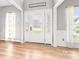 Bright foyer with stylish front door, light wood floors, and neutral decor at 4469 Greystone Sw Dr, Concord, NC 28027