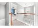 Bright hallway with view to bedroom featuring a ceiling fan, light fixture, and nice trim work at 4469 Greystone Sw Dr, Concord, NC 28027