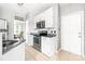 Well-lit kitchen featuring white cabinets, stainless steel appliances, and granite countertops at 4469 Greystone Sw Dr, Concord, NC 28027