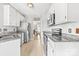 Kitchen featuring stainless steel appliances, granite countertops, white cabinetry and tile flooring at 4469 Greystone Sw Dr, Concord, NC 28027