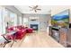 Cozy living room with fireplace, ceiling fan, and hardwood floors, flowing into open-concept living space at 4469 Greystone Sw Dr, Concord, NC 28027