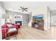Open-concept living room featuring fireplace and a television, complemented by hardwood floors at 4469 Greystone Sw Dr, Concord, NC 28027