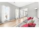 Bright living room with hardwood floors, neutral walls, and large windows with curtains at 4469 Greystone Sw Dr, Concord, NC 28027