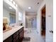 Bathroom featuring a double vanity, tiled glass enclosed walk-in shower, and view into the walk-in closet at 5121 Arbordale Way, Mount Holly, NC 28120