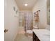 Cozy bathroom with shower-tub combo and decorative shelves for extra storage at 5121 Arbordale Way, Mount Holly, NC 28120