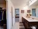 Bathroom featuring a double vanity, walk-in closet, and view of the bedroom at 5121 Arbordale Way, Mount Holly, NC 28120