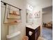 Neutral bathroom with decoratively staged wall shelves and dark wood vanity at 5121 Arbordale Way, Mount Holly, NC 28120