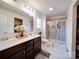 Bright bathroom featuring a double vanity, and tiled glass enclosed walk-in shower at 5121 Arbordale Way, Mount Holly, NC 28120