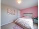 Bright bedroom featuring stylish accents, a pink wall, and plush carpeting at 5121 Arbordale Way, Mount Holly, NC 28120