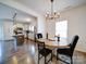 Inviting dining room with modern chandelier and adjacent kitchen with a stainless steel refrigerator at 5121 Arbordale Way, Mount Holly, NC 28120