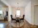 Inviting dining room with modern chandelier and adjacent kitchen, perfect for entertaining at 5121 Arbordale Way, Mount Holly, NC 28120