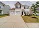 Inviting two-story home boasting a three-car garage, manicured lawn, and tidy landscape at 5121 Arbordale Way, Mount Holly, NC 28120