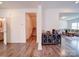 Hallway with hardwood floors, a storage cabinet, and access to the living and stairwell at 5121 Arbordale Way, Mount Holly, NC 28120