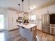 Modern kitchen with an island, stainless steel appliances, and white cabinets at 5121 Arbordale Way, Mount Holly, NC 28120