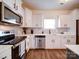 Modern kitchen with white cabinets, stainless steel appliances, and sleek countertops at 5121 Arbordale Way, Mount Holly, NC 28120