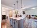Spacious kitchen featuring a large center island, pendant lighting, and an open layout to the dining and living areas at 5121 Arbordale Way, Mount Holly, NC 28120