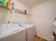 Practical laundry room with washer, dryer, and overhead wire shelving for storage at 5121 Arbordale Way, Mount Holly, NC 28120