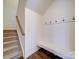 Functional mud room with built-in bench, hooks, and storage space by the staircase at 5121 Arbordale Way, Mount Holly, NC 28120