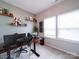 Bright office space with lots of light, floating shelves, and sleek computer setup at 5121 Arbordale Way, Mount Holly, NC 28120