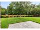 Well manicured backyard features a lush lawn, wooden fence, and patio at 5707 Sustar Dr, Monroe, NC 28110