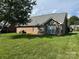 View of the brick home's exterior and the lush green lawn at 5707 Sustar Dr, Monroe, NC 28110