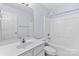 Clean bathroom featuring a vanity with a mirror, a toilet, and a shower-tub combination with white walls at 5707 Sustar Dr, Monroe, NC 28110
