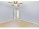 A bedroom with carpet and light walls has a ceiling fan and a door leading to other rooms at 5707 Sustar Dr, Monroe, NC 28110