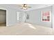 Bright bedroom has carpet, a ceiling fan, and doors leading to a closet and bathroom at 5707 Sustar Dr, Monroe, NC 28110