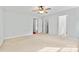 A spacious bedroom with carpet, light walls and doors leading to multiple other rooms at 5707 Sustar Dr, Monroe, NC 28110