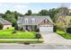 Beautiful brick home with lush lawn, dormer windows, and a two-car garage at 5707 Sustar Dr, Monroe, NC 28110
