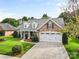 A charming brick home with a well-manicured front yard and two-car garage at 5707 Sustar Dr, Monroe, NC 28110