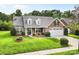A charming brick home with a well-manicured front yard and two-car garage at 5707 Sustar Dr, Monroe, NC 28110