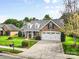 A charming brick home with a well-manicured front yard and two-car garage at 5707 Sustar Dr, Monroe, NC 28110