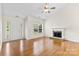 Cozy living room with hardwood floors, fireplace, and a front door at 5707 Sustar Dr, Monroe, NC 28110