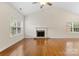 Inviting living room with hardwood floors, fireplace, and large windows at 5707 Sustar Dr, Monroe, NC 28110