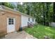 Rear exterior with brick facade, white trim, and a small deck at 6215 Cross Creek Ln, Charlotte, NC 28212
