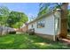 Back exterior view of the house with yard and small deck at 6215 Cross Creek Ln, Charlotte, NC 28212