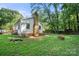 A charming backyard with a brick fire pit next to a white house with brick chimney at 6215 Cross Creek Ln, Charlotte, NC 28212