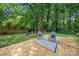 Backyard deck with chairs, rug, and tree swing, perfect for relaxing at 6215 Cross Creek Ln, Charlotte, NC 28212