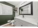 Updated bathroom with a modern vanity, a dark accent wall, and a large mirror at 6215 Cross Creek Ln, Charlotte, NC 28212