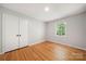 Well-lit bedroom with hardwood floors, a bright window, and a double-door closet at 6215 Cross Creek Ln, Charlotte, NC 28212
