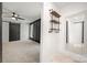 Entryway leading into a bedroom with a fan, dark accent wall, bright window, and updated storage at 6215 Cross Creek Ln, Charlotte, NC 28212