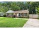 Beautiful exterior of a brick home with a well-kept lawn and a double-gate driveway at 6215 Cross Creek Ln, Charlotte, NC 28212